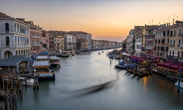 Long exposure, view over the Grand Canal with gondolier at sunset, from the Rialto Bridge, Venice,