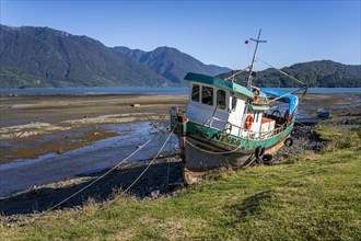 Boat at low tide, Hornopiren Waterfront, Hornopiren, Carretera Austral, Chile, South America