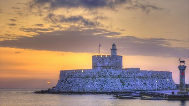 The fortress near the coast under a sky with sunset colours, sunrise, dawn, lighthouse, European