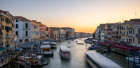 Vaporettos on the Grand Canal at sunset, long exposure, view from the Rialto Bridge, Venice,