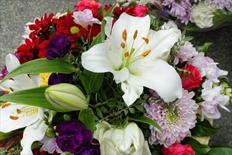 Colourful flower arrangement with white Lily (Lilium candidum) and purple accents, flower sale,