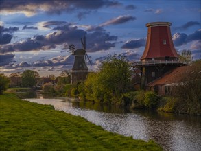 The twin mills at the old Greetsieler Sieltief at sunset, Greetsiel, Krummhoern, East Frisia, Lower