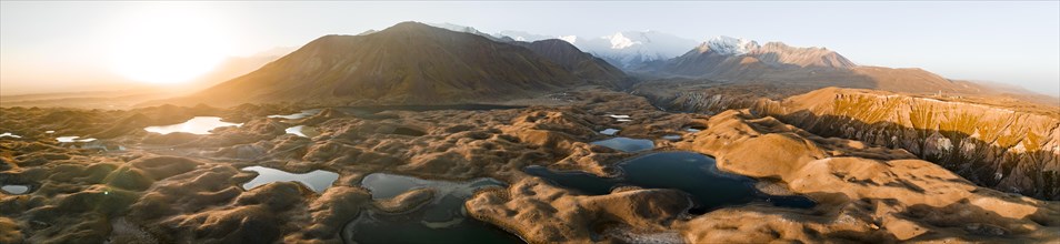 Aerial view, high mountain landscape with glacial moraines and mountain lakes, behind Pik Lenin,