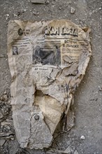 Remains of an old Kyrgyz newspaper from 1924 with Cyrillic writing in an abandoned building, ghost
