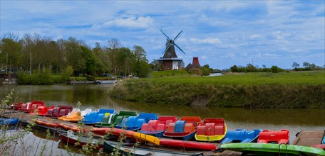 The Greetsiel twin mills, in front boats in the new Greetsieler Sieltief, panoramic photo,