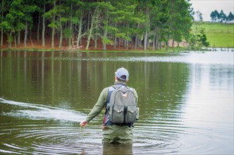 Black bass fisherman fishing inside lake, Cambara do sul, Rio Grande do sul, Brazil, South America