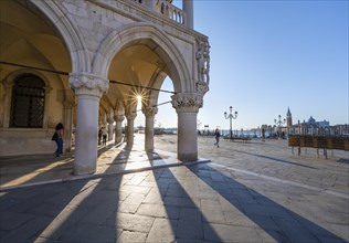 Colonnade of the Doge's Palace with Sun Star in the Piazetta San Marco, St Mark's Square, Venice,