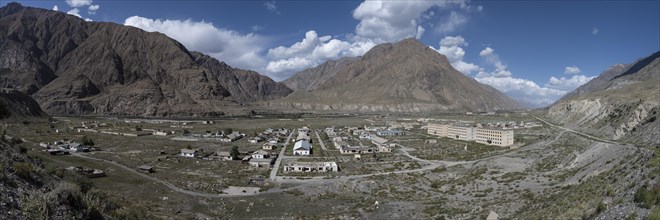 Town view, Abandoned buildings in barren landscape, Ghost town Enilchek in the Tien Shan Mountains,