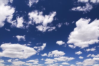 Blue sky with puffy white cumulus clouds in late spring, Quebec, Canada, North America