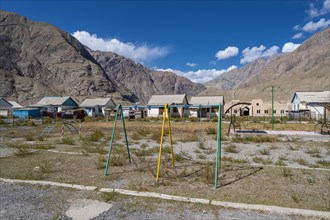 Swings on a playground, ghost town, Engilchek, Tian Shan, Kyrgyzstan, Asia