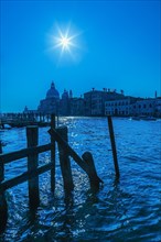 Silhouetted view of Grand canal with water taxis, Santa Maria della Salute basilica and Renaissance