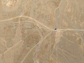 Aerial view, Vast empty landscape, Road and off-road vehicle, Top down view, Two paths divide,