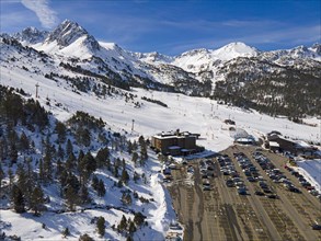 Aerial view of a car park at a ski resort with mountain scenery in the background, Grau Roig,