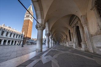 Colonnade of the Doge's Palace with Campanile bell tower in Piazetta San Marco, St Mark's Square,