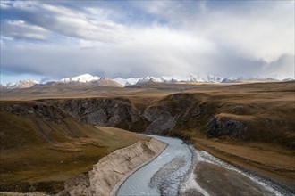 Mountain valley with Sary Jaz river, high glaciated mountain peaks of the Tien Shan in the