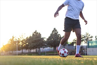 Football player on the field running with the ball. Close up of player's feet running with the ball