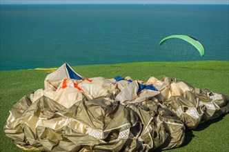 Camboriu, Brazil, December 10, 2017: Students practicing paragliding on the hill, South America