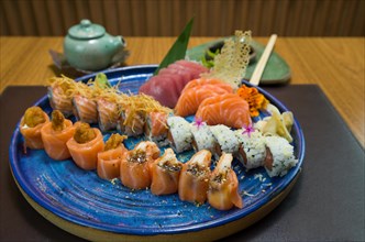 Combined of differents japanese sushi on a elegant blue plate