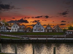 Historic houses at Greetsiel harbour at sunset, Greetsiel, Krummhoern, East Frisia, Lower Saxony,