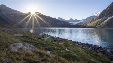 Hiker, camping in the wilderness, mountain lake in the Tien Shan, Lake Ala-Kul, Kyrgyzstan, Asia