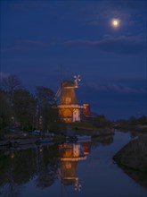 The Greetsiel Twin Mills at full moon, the Green Mill is reflected in the Old Greetsiel Deep,