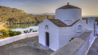 Small white chapel overlooking the calm sea at dawn, Lindos, Rhodes, Dodecanese, Greek Islands,