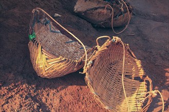 Close up of three woven wicker baskets that are used to gather and carry harvested salt in Kampot
