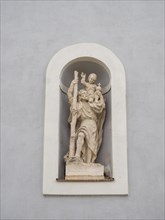 Sculpture on the church wall, St Christopher, parish church zum Heiland, Roman Catholic parish