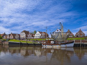 Fishing boat and historic houses at Greetsiel harbour, Greetsiel, Krummhoern, East Frisia, Lower