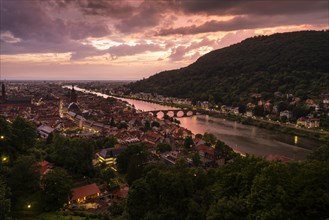 The city of Heidelberg at sunset after a thunderstorm with a special lighting mood. The river