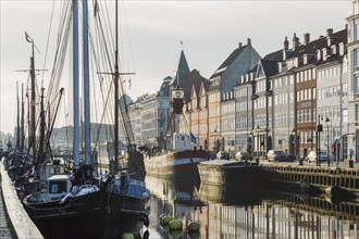 Moored ships and colourful 17th century apartment buildings and houses along the Nyhavn canal,