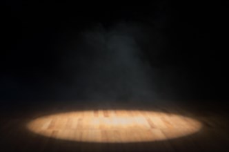 Single focus of light on a theater stage without anything, focus of light on a wooden floor and