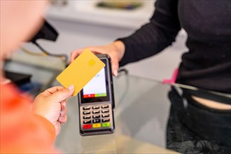 Close-up of a customer paying with credit card in a hair salon