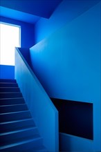 AI generated minimalist architectural shot of blue walls intersecting around a modern stairway