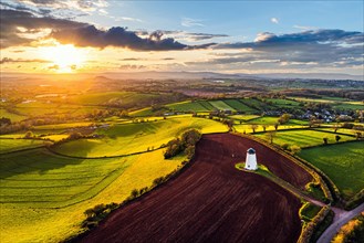 Sunset of Devon Windmill over Fields and Farms from a drone, Torquay, Devon, England, United