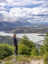 Young woman standing in front of Lago Grey, Hike to Ferrier lookout, Torres de Paine, Magallanes