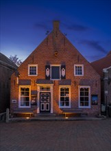 Historic brick house at Greetsiel harbour at sunset, Greetsiel, Krummhoern, East Frisia, Lower