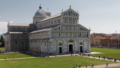 Historic cathedral in Pisa under a clear blue sky with visitors in front of it, Pisa Italy Europe