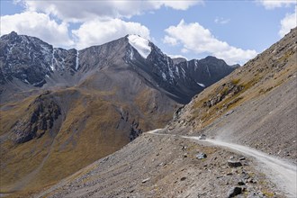 Off-road car on mountain pass, gravel road in the mountains in Tien Shan, Engilchek Valley,
