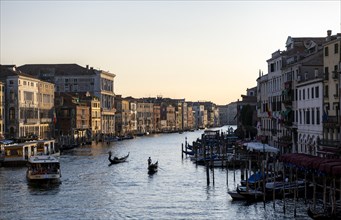 View over the Grand Canal with gondolier and vaporetto in the evening light, from the Rialto