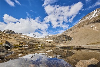 Puddle next to Wasserfallwinkelkeesee in the mountains (Grossglockner) in summer on a sunny day,
