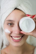 Skincare, product and woman with cream on face, and excited advertising luxury skin care promotion.