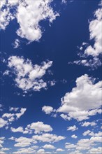 Blue sky with puffy white cumulus clouds in late spring, Quebec, Canada, North America