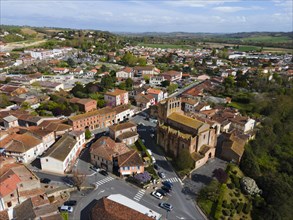 Aerial view of a town with centre around a large church, clear street structure visible, parish