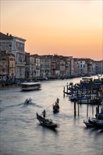 Long exposure, view over the Grand Canal with gondolier at sunset, from the Rialto Bridge, Venice,