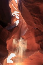 Sunbeams dance on the eroded surfaces of a narrow canyon, Upper Antelope Canyon, North America,