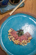 Delicious premium tuna sashimi arranged on an elegant handmade platter