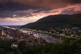 The city of Heidelberg at sunset after a thunderstorm with a special lighting mood. The river