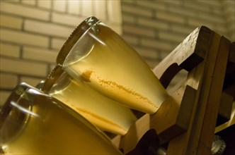 Bottles in the pupitres for the yeasts to accumulate in the neck of the bottle