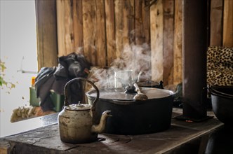 Beautiful steel kettle on wood stove in the countryside, Cambara do sul, Rio Grande do sul, Brazil,